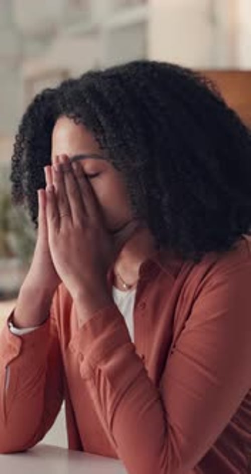 Sad Woman Covering Face with Hands Indoors