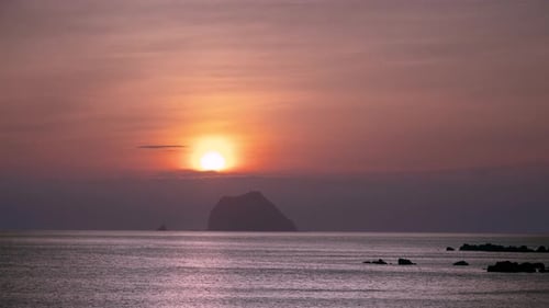 Spectacular Sunrise over Keelung Islet Taiwan with Black Clouds and Orange Sky.