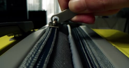 Extreme Close Up of Zipper on Yellow Suitcase
