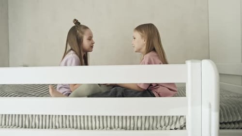 Girls Chatting Together on Bunk Bed Indoors
