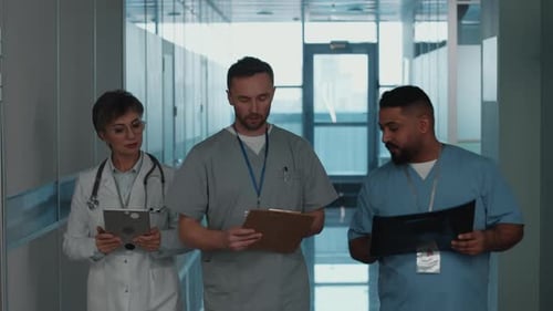 Medical Staff Discussing Patient Care in Hospital Hallway