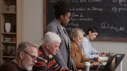 Adults Learning Internet Skills with Instructor in Classroom