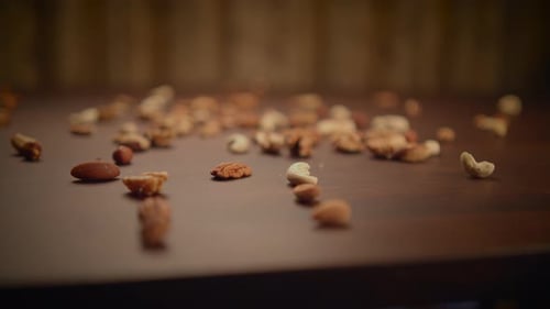 Variety of nuts scattered across a wooden table