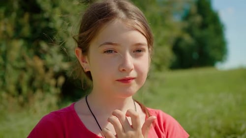 Girl Eats Fruit Outdoors on Sunny Day