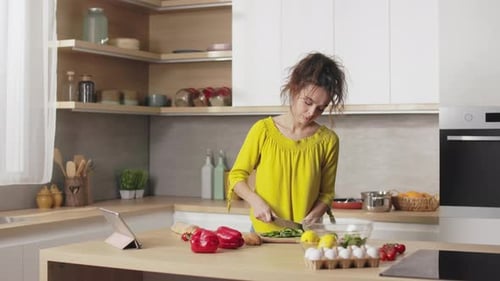 Woman Prepares Fresh Food in Sunny Kitchen