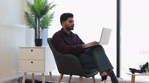 Young Adult Working on Laptop from Home