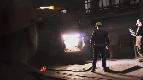 Workers in a Steel Factory are Collaboratively Engaged in a Heavy Manufacturing Process Stock Clip