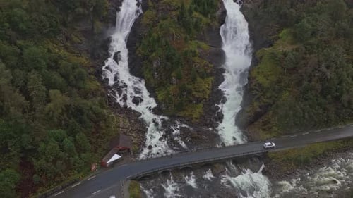 Waterfall flows through remote canyon in Norway from the sky