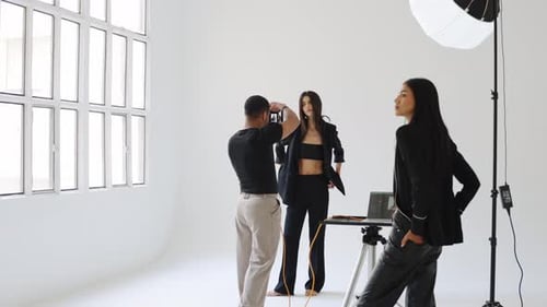 Fashion Photographer Taking Pictures of Model in Studio