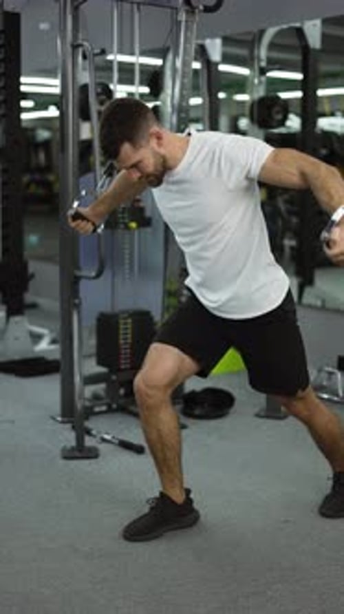 Bodybuilder Guy in Gym Pumping Up Hands in Headphones From the Sides Slow Motion