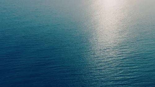 Aerial View of the Sunny Path on the Surface of the Ocean at Sunset