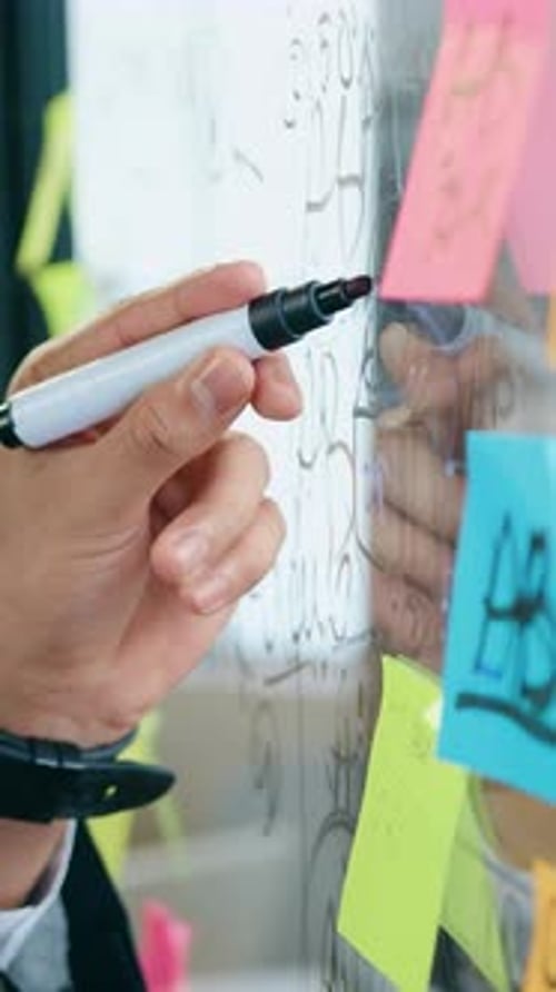 Workflow Concept Where Unknown Man Working on Glass Board Memo in Office Room Recording Important
