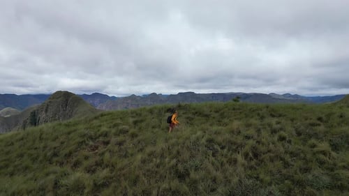 Panoramic view of hiker on rugged mountainous Codo de los Andes trail