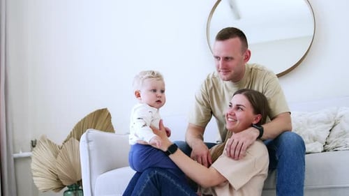 Loving Family Smiling Together Indoors