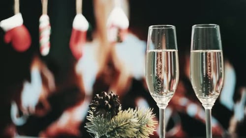 Champagne Flutes with Christmas Decorations and Fireplace