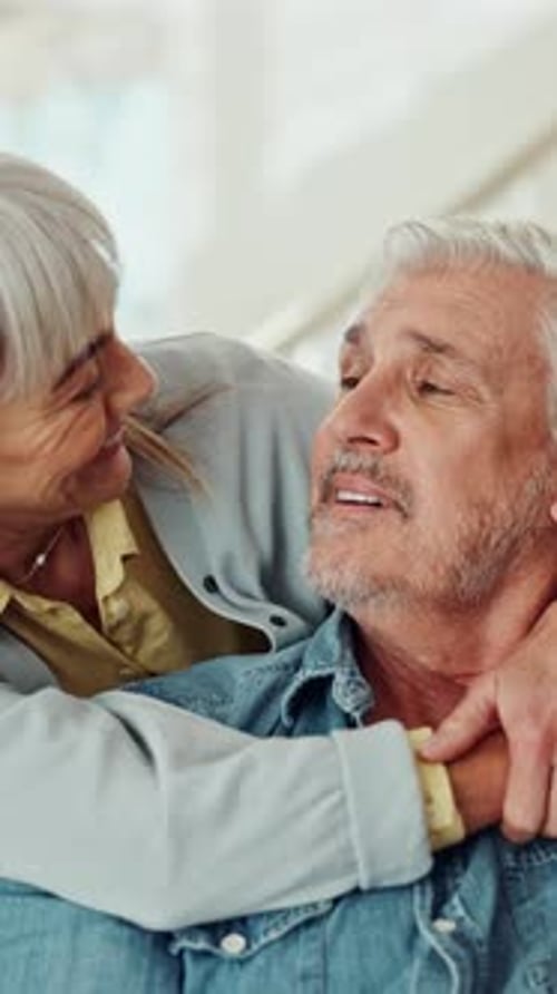Senior Couple Embracing Indoors in a Close Up