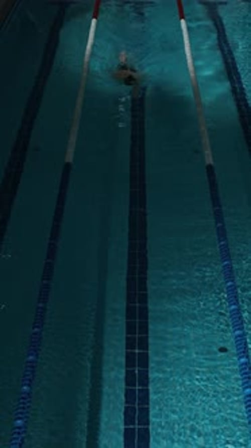 Swimmer Practicing Front Crawl in Indoor Pool