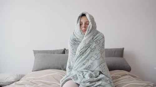 Young Woman Cozy in Plaid Freezing at Home Cold Winter at Home Energy Crisis