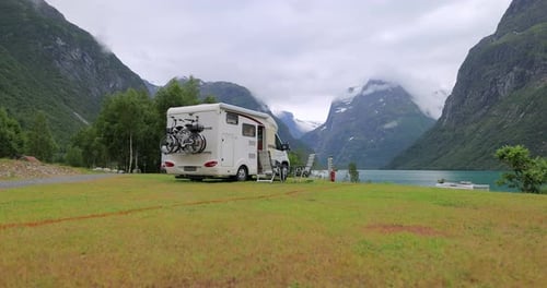 Camper Van Parked by Scenic Mountain Lake