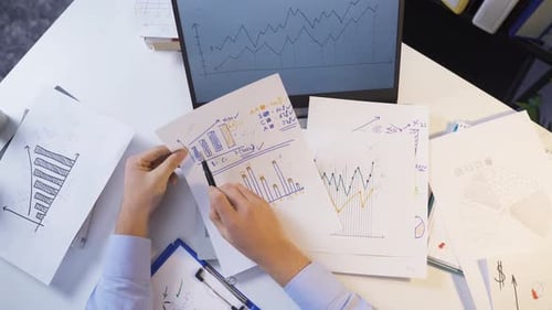 Businessman is working and analyzing financial statistics in his office.