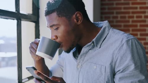 Coffee, window and man with phone reading digital news article, social network post