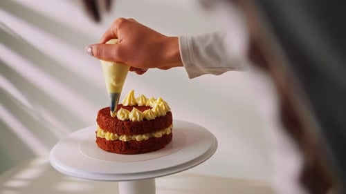 Icing Being Added to Delicious Two Layer Cake