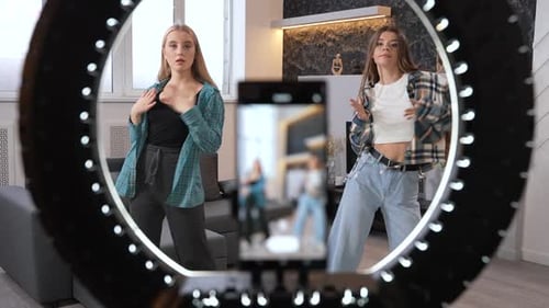 Two Young Women Dancing in Front of Camera