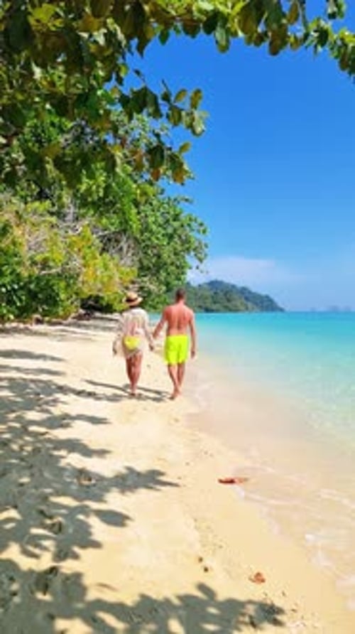 a Man and a Woman are Walking on a Beach Holding Hands Koh Kradan Thailand