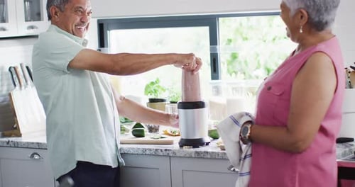 Senior Couple Makes Healthy Smoothie Together at Home