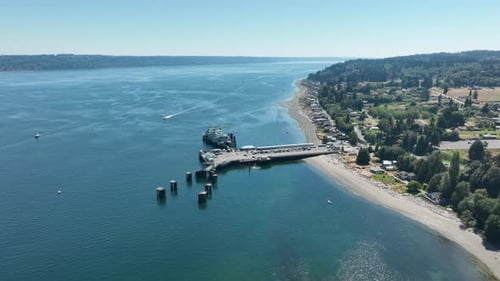 Wide shot pulling away from a docked ferry in Washington State.