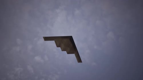 Stealth Bomber Flying at Sunset