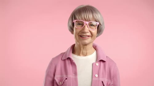 Smiling Senior Woman with Pink Glasses