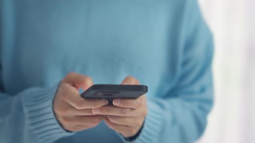 Person Typing on Smartphone, Close Up
