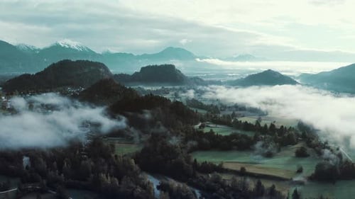 Aerial view of ASMR soft mystical clouds over the rural valley in the morning.