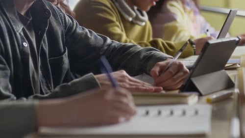 Zoomers Taking Notes and Communicating during Lecture in Auditorium