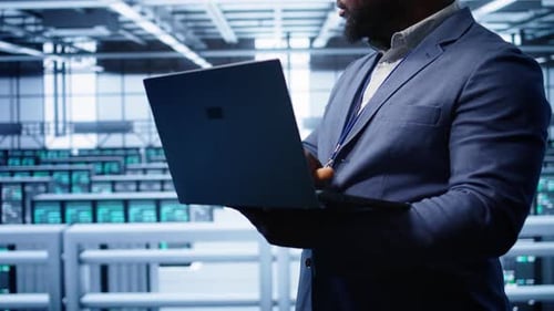 Computer Scientist in Data Center Facility Using Laptop to Patch Network Issues
