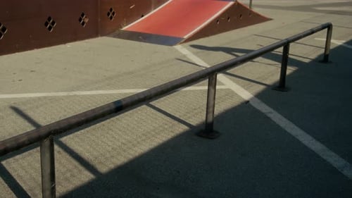 BMX Cyclist Performing Hop over Rail in Urban Skate Park