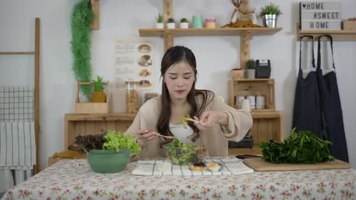 Woman Eats a Healthy Salad in Bright Kitchen