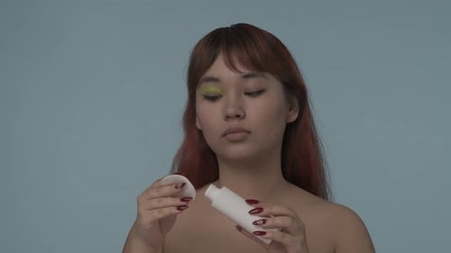 Closeup Isolated Slow Motion Video of a Young Seminude Woman with Red Dyed Hair and Nude Makeup