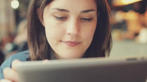 4k video footage of a businesswoman working in a cafe while using a digital tablet