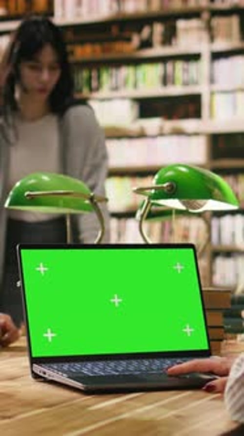 Vertical Video Green Screen Mockup on Laptop Inside University Library Desk