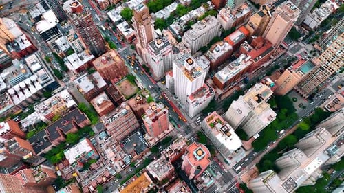 Lively traffic on the straight street crossing the cityscape of New York.