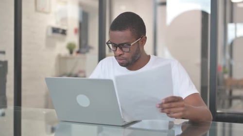 Man Receives Good News on Laptop and Celebrates