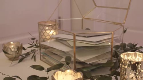 Elegant Gold Rimmed Glass Card Holder and Candles at Wedding Reception.