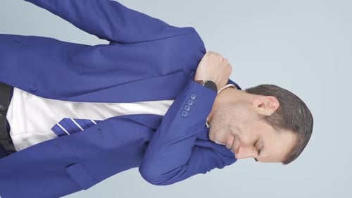 Man in Suit Rubbing Aching Shoulder