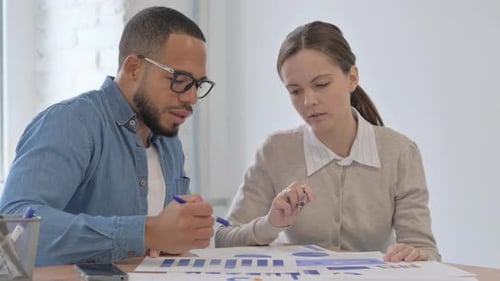 Multi Ethnic People Working on Documents in Office