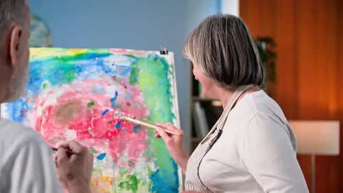 Senior Couple Painting Colorful Abstract Art Together Indoors