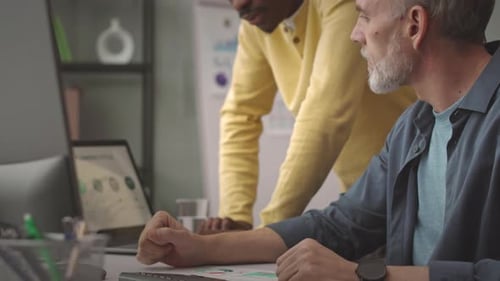 Two Men Planning Business Finances in Office