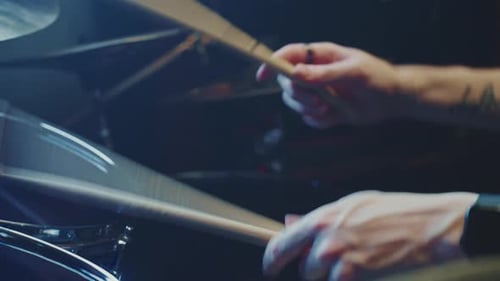 Drummer Playing Drum Set with Sticks
