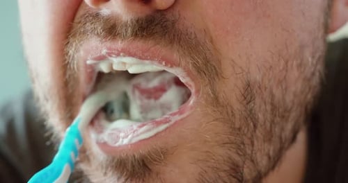 Man Brushing Back Teeth Close Up